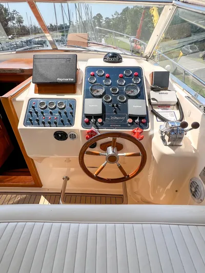 A'maure Yacht Photos Pics Helm of 2001 Apreamare 11 yacht with navigation instruments and wooden steering wheel.
