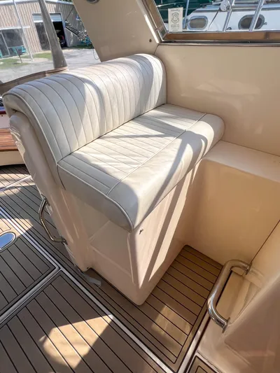 A'maure Yacht Photos Pics White leather seat on 2001 Apreamare 11 boat with wooden deck flooring.