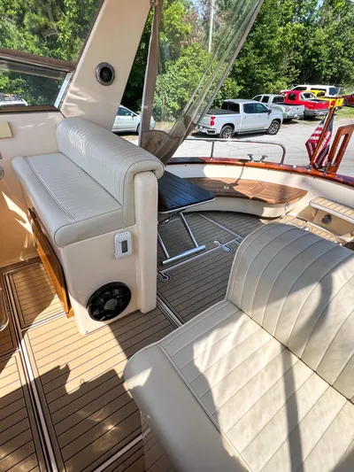 A'maure Yacht Photos Pics Interior of 2001 Apreamare 11 boat with beige seating and wooden flooring.