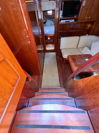A'maure Yacht Photos Pics Interior of 2001 Apreamare 11 yacht with wooden stairs and cozy seating area.