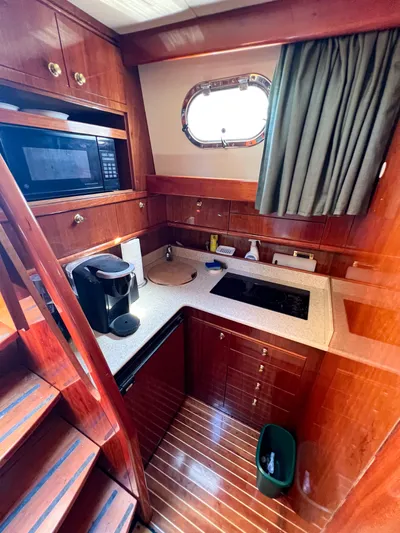 A'maure Yacht Photos Pics Luxurious 2001 Apreamare 11 yacht kitchen with wood cabinetry and modern appliances.