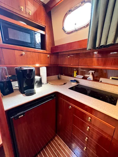 A'maure Yacht Photos Pics Luxurious 2001 Apreamare 11 yacht kitchen with wood cabinetry, microwave, and coffee maker.