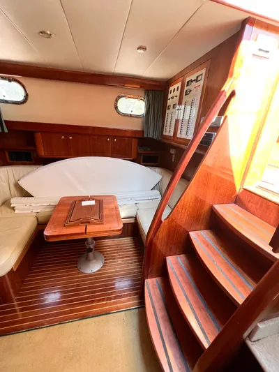 A'maure Yacht Photos Pics Interior of 2001 Apreamare 11 yacht with wooden stairs and seating area.