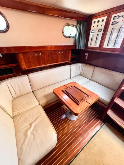 A'maure Yacht Photos Pics Luxurious interior of 2001 Apreamare 11 yacht with plush seating and wooden accents.