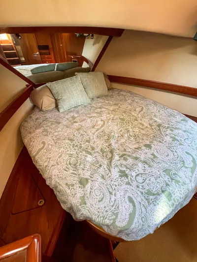 A'maure Yacht Photos Pics Cozy cabin interior of 2001 Apreamare 11 yacht with patterned bedding and wooden accents.