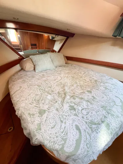 A'maure Yacht Photos Pics Cozy bedroom in 2001 Apreamare 11 yacht with patterned bedding and wooden accents.