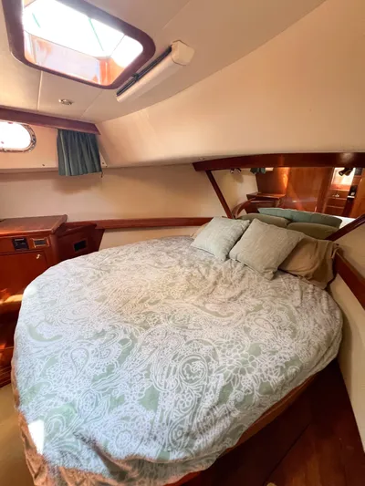 A'maure Yacht Photos Pics Cozy bedroom in 2001 Apreamare 11 yacht with skylight and elegant bedding.