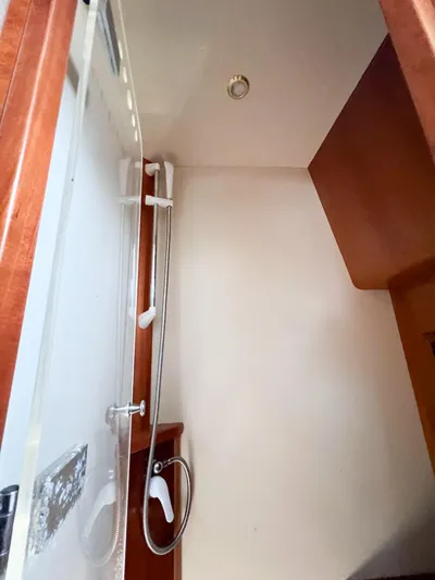 A'maure Yacht Photos Pics Shower area inside 2001 Apreamare 11 boat, featuring wooden accents and modern fixtures.