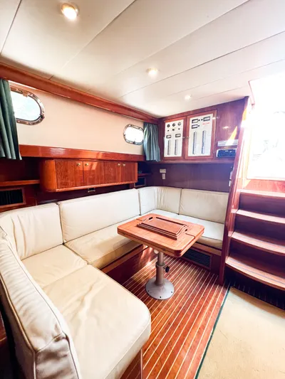 A'maure Yacht Photos Pics Interior of 2001 Apreamare 11 yacht with cozy seating and wooden finishes.