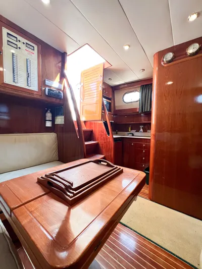 A'maure Yacht Photos Pics Interior of 2001 Apreamare 11 yacht with wooden furnishings and compact kitchen area.