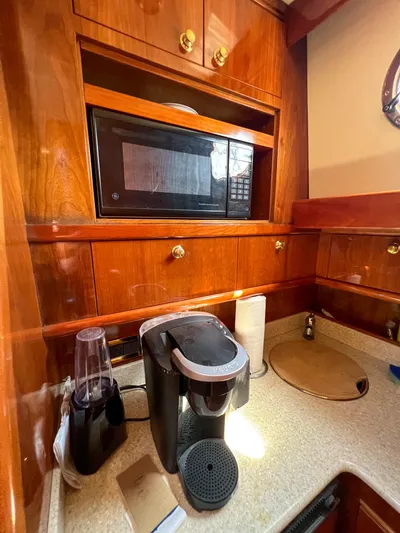 A'maure Yacht Photos Pics Kitchen area of a 2001 Apreamare 11 yacht with microwave and coffee maker.