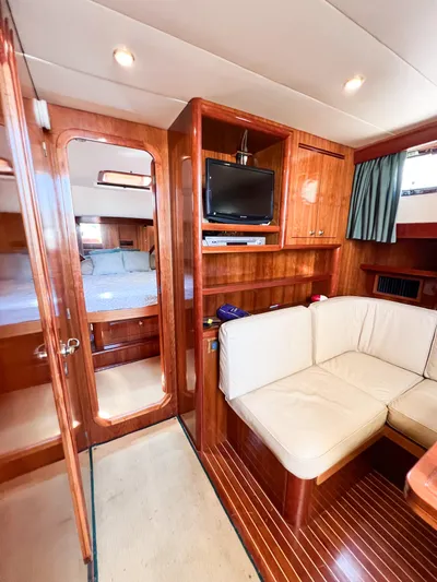 A'maure Yacht Photos Pics Luxurious interior of 2001 Apreamare 11 yacht with wood finish and cozy seating area.