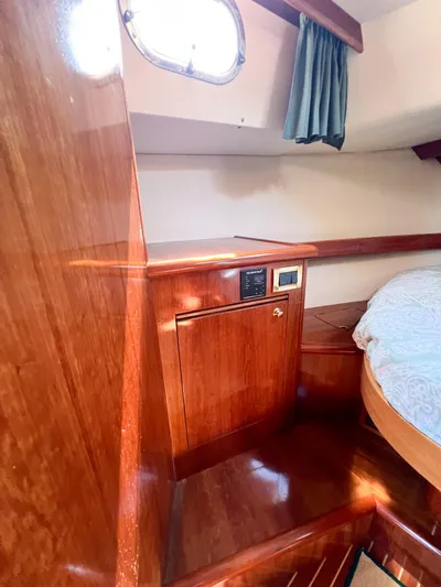 A'maure Yacht Photos Pics Interior of 2001 Apreamare 11 yacht with wooden cabinetry and cozy sleeping area.