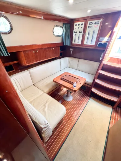 A'maure Yacht Photos Pics Luxurious 2001 Apreamare 11 yacht interior with wooden finishes and cozy seating area.
