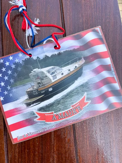 A'maure Yacht Photos Pics Apreamare 11 boat on water with American flag background, labeled "A'Maur'e."