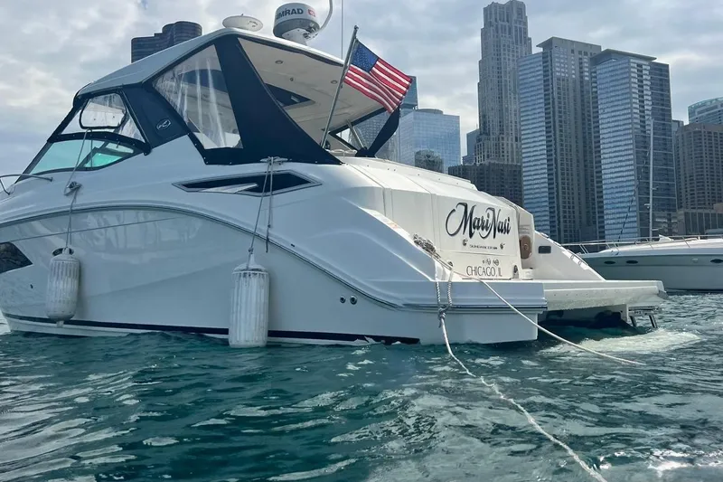  Yacht Photos Pics 2019 Sea Ray Sundancer 320 yacht docked in urban marina with city skyline.