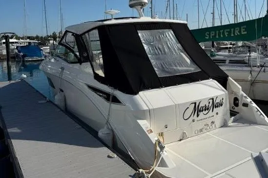  Yacht Photos Pics 2019 Sea Ray Sundancer 320 docked at marina, featuring sleek design and black canopy.