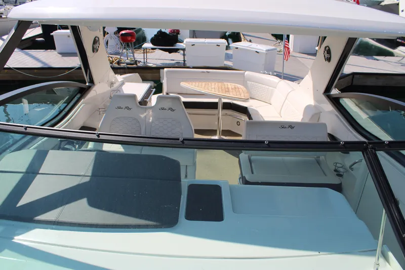  Yacht Photos Pics 2019 Sea Ray Sundancer 320 boat interior with seating and table, docked at marina.