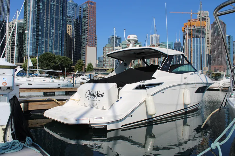  Yacht Photos Pics 2019 Sea Ray Sundancer 320 docked in urban marina with city skyline.