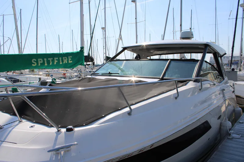  Yacht Photos Pics 2019 Sea Ray Sundancer 320 docked at marina with sailboats in background.