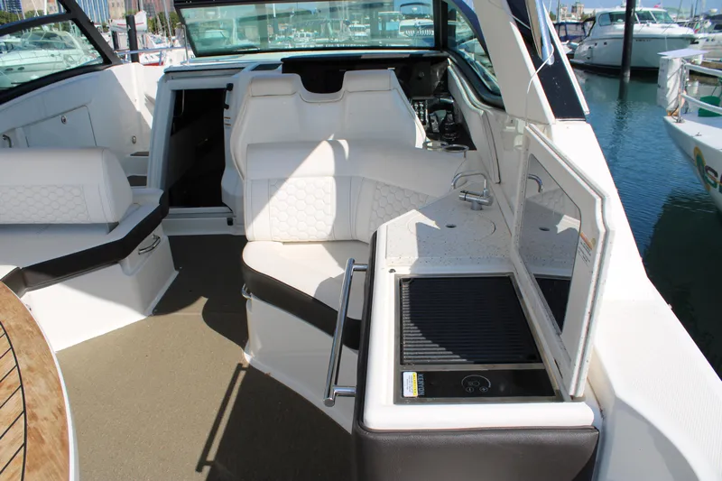  Yacht Photos Pics 2019 Sea Ray Sundancer 320 interior with seating and kitchenette, docked at marina.