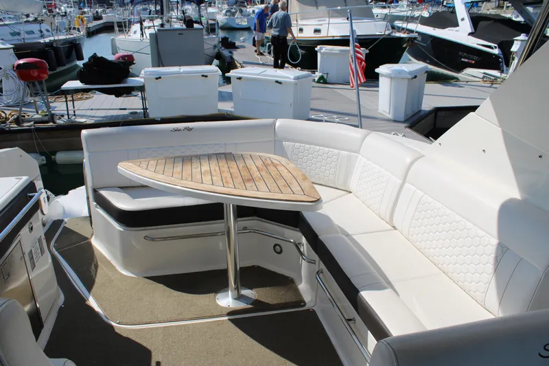  Yacht Photos Pics Luxurious seating area on a 2019 Sea Ray Sundancer 320 yacht at a marina.