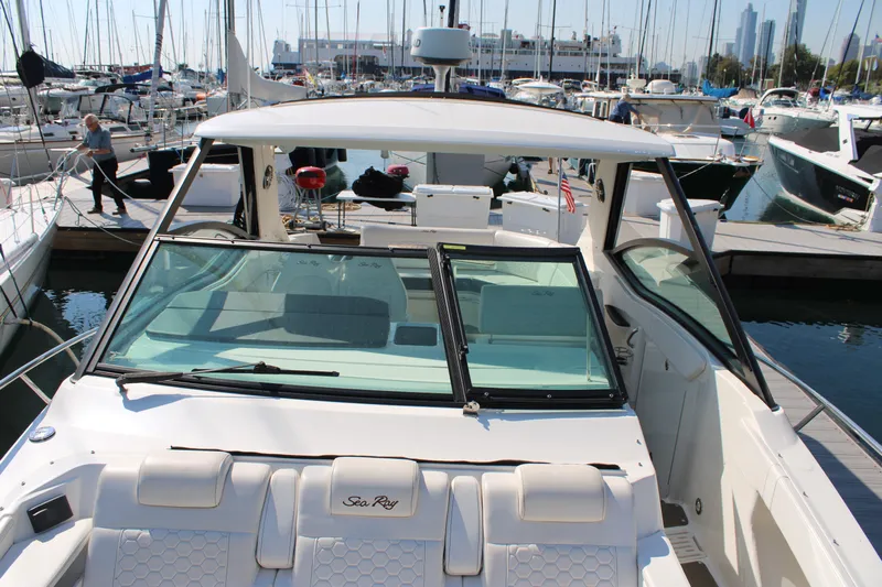  Yacht Photos Pics 2019 Sea Ray Sundancer 320 docked at marina, surrounded by other boats.