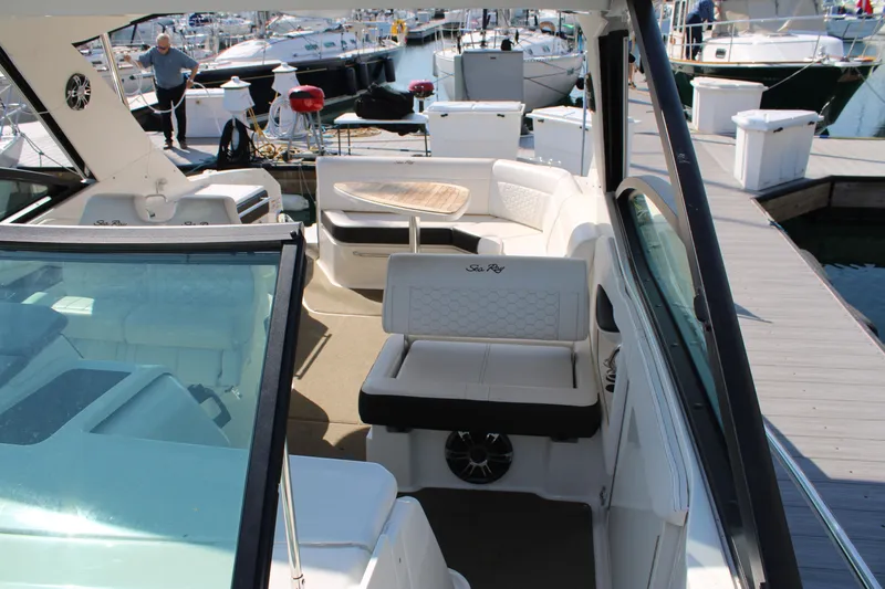  Yacht Photos Pics 2019 Sea Ray Sundancer 320 interior with seating and table at marina dock.