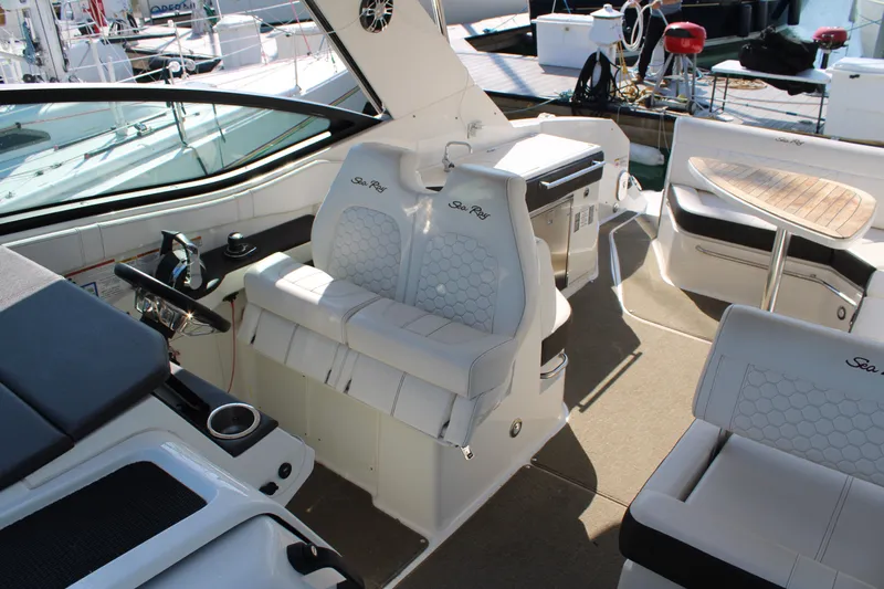  Yacht Photos Pics 2019 Sea Ray Sundancer 320 interior with helm, seating, and table on deck.