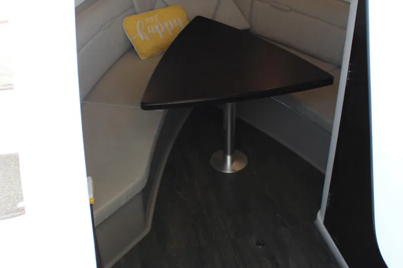  Yacht Photos Pics 2019 Sea Ray Sundancer 320 interior with triangular table and "be happy" pillow.