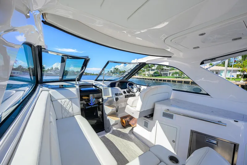 Damn Daddy Yacht Photos Pics Luxurious interior of 2020 Regal 35 Sport Coupe yacht with plush seating and modern helm.