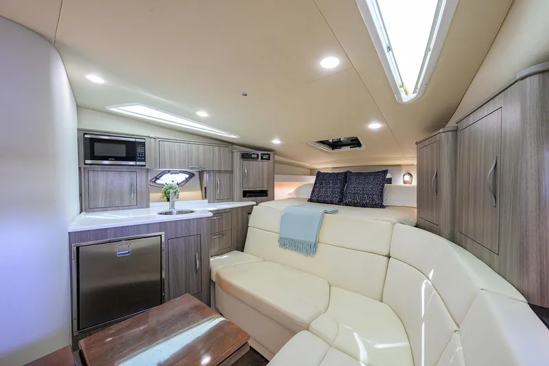 Damn Daddy Yacht Photos Pics Luxurious interior of 2020 Regal 35 Sport Coupe with modern kitchen and cozy seating area.