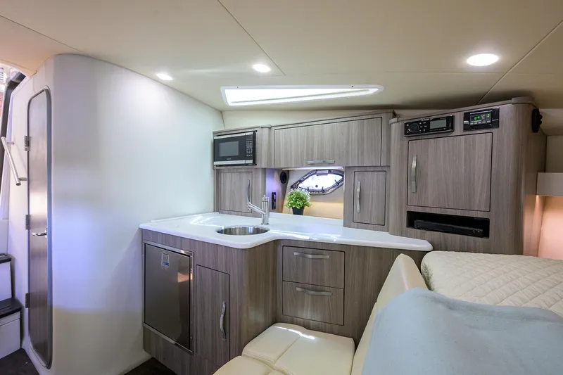 Damn Daddy Yacht Photos Pics 2020 Regal 35 Sport Coupe interior with modern kitchenette and cozy seating area.