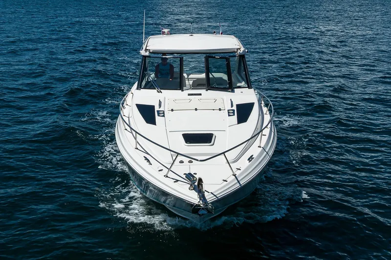 Damn Daddy Yacht Photos Pics 2020 Regal 35 Sport Coupe cruising on open water, front view.