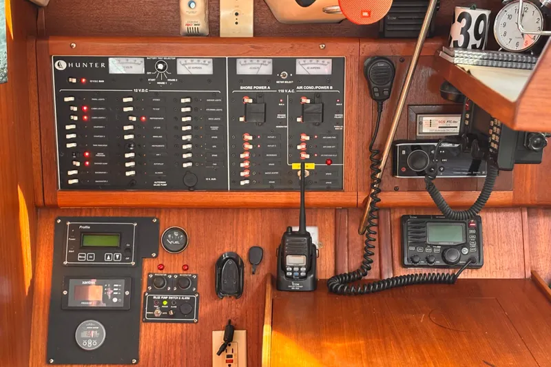 Orion Yacht Photos Pics Control panel of a 2002 Hunter 410 sailboat with various navigation and communication devices.