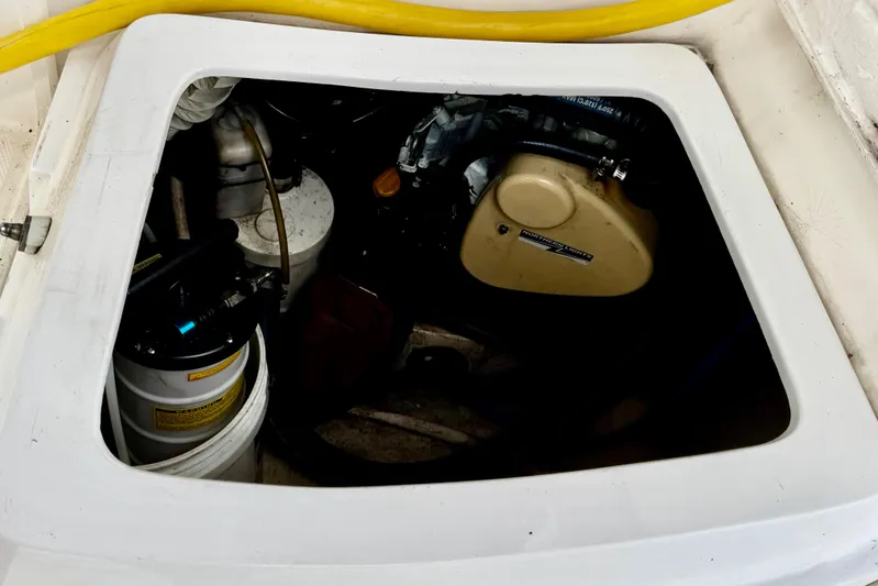 Orion Yacht Photos Pics Engine compartment of a 2002 Hunter 410 sailboat, featuring mechanical components and hoses.