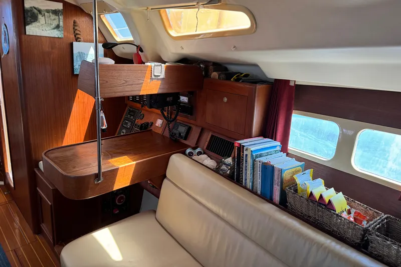 Orion Yacht Photos Pics Interior of a 2002 Hunter 410 sailboat with navigation station and bookshelf.