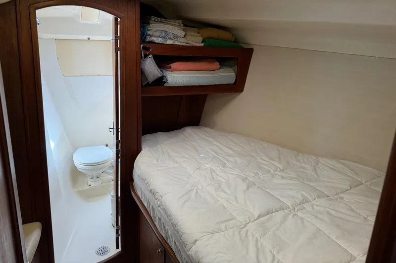 Orion Yacht Photos Pics Cozy cabin interior of 2002 Hunter 410 sailboat with bed and compact bathroom.