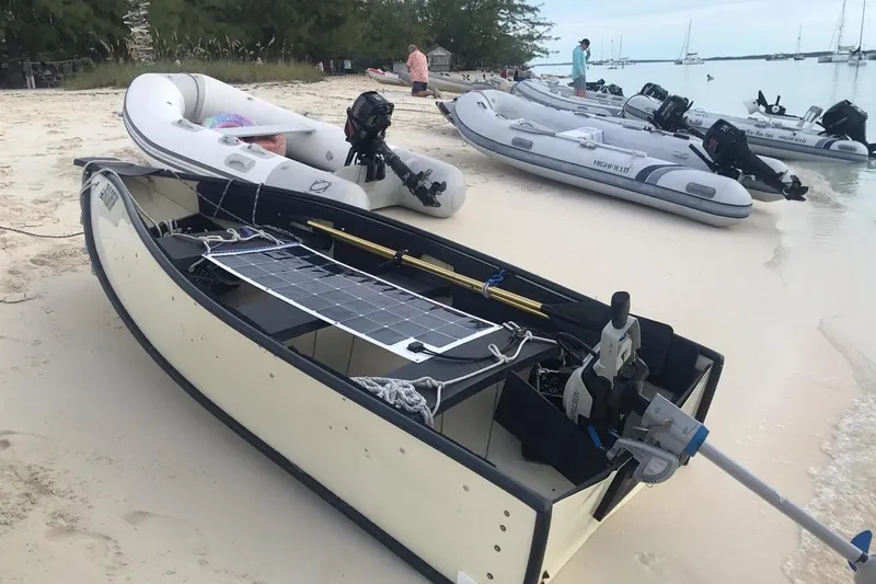 Orion Yacht Photos Pics Small boats, including a 2002 Hunter 410, docked on a sandy beach.