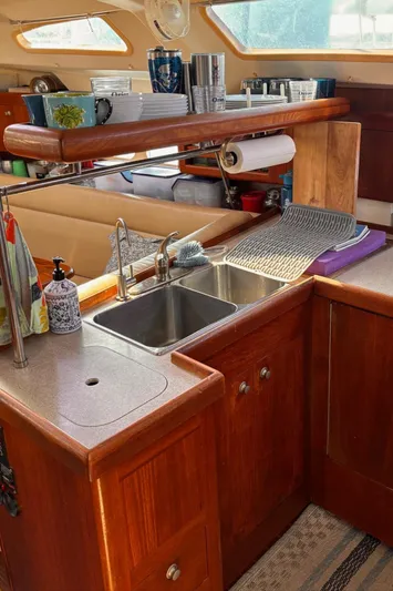 Orion Yacht Photos Pics Hunter 410 yacht kitchen interior with wooden cabinets and dual sink, 2002 model.