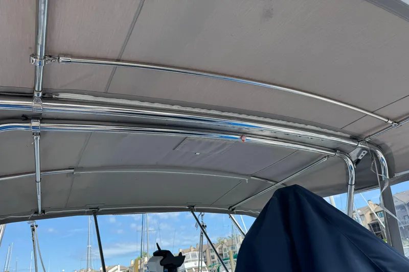 Orion Yacht Photos Pics Bimini top of a 2002 Hunter 410 sailboat, with marina background.