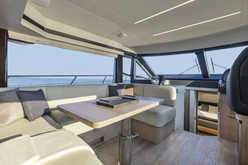 Absolute 50 Fly Yacht Photos Pics Luxurious interior of 2025 Absolute 50 Fly yacht with modern seating and panoramic windows.