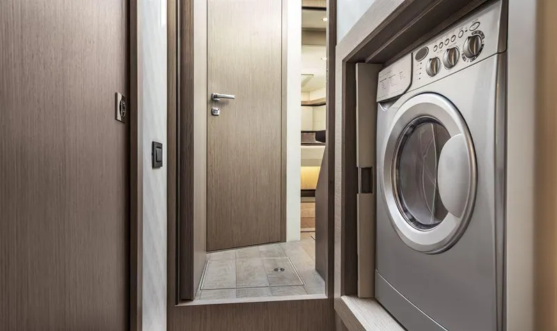 Absolute 50 Fly Yacht Photos Pics Laundry area inside 2025 Absolute 50 Fly yacht, featuring a modern washing machine.