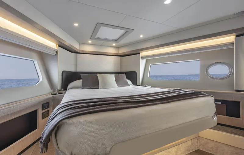 Absolute 50 Fly Yacht Photos Pics Luxurious bedroom interior of 2025 Absolute 50 Fly yacht with ocean view windows.
