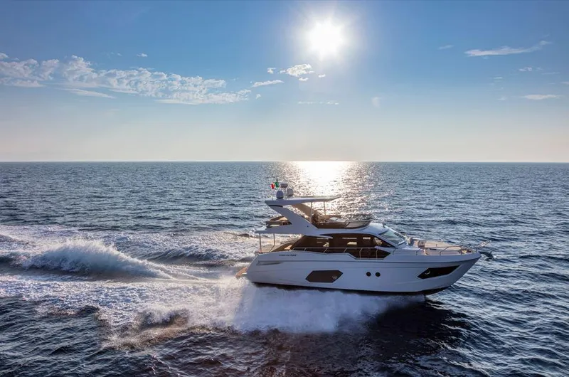 Absolute 50 Fly Yacht Photos Pics 2025 Absolute 50 Fly yacht cruising on open sea under bright sun.
