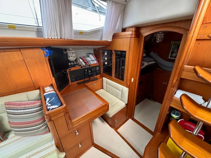  Yacht Photos Pics Luxurious interior of a 2003 Oyster 56 yacht with wood finish and seating area.
