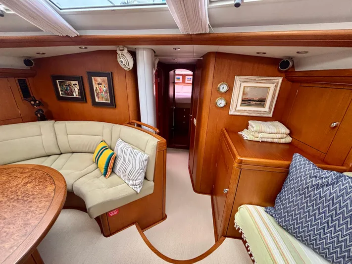  Yacht Photos Pics Luxurious 2003 Oyster 56 yacht interior with cozy seating, elegant wood finish, and nautical decor.