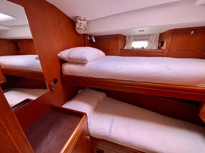  Yacht Photos Pics Cozy cabin with wooden bunk beds in a 2003 Oyster 56 yacht.