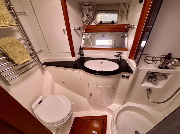  Yacht Photos Pics Luxurious bathroom in 2003 Oyster 56 yacht with modern fixtures and elegant design.