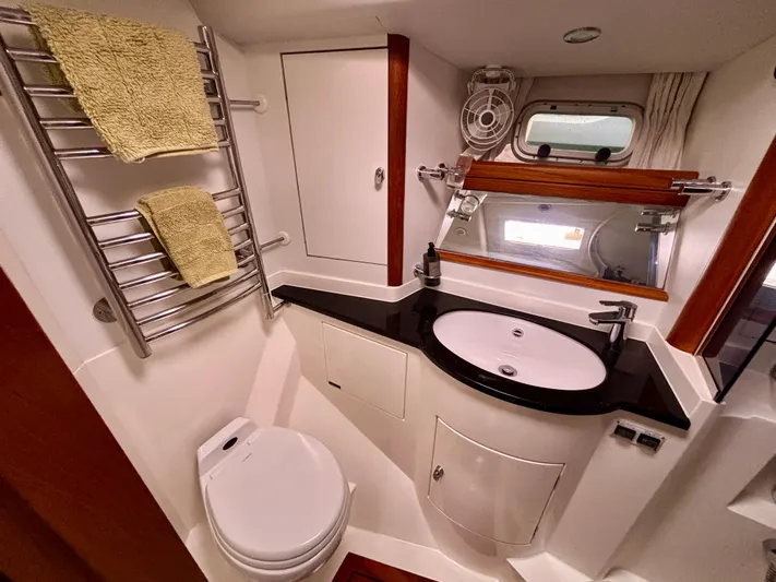  Yacht Photos Pics Luxurious bathroom in 2003 Oyster 56 yacht with modern fixtures and elegant design.